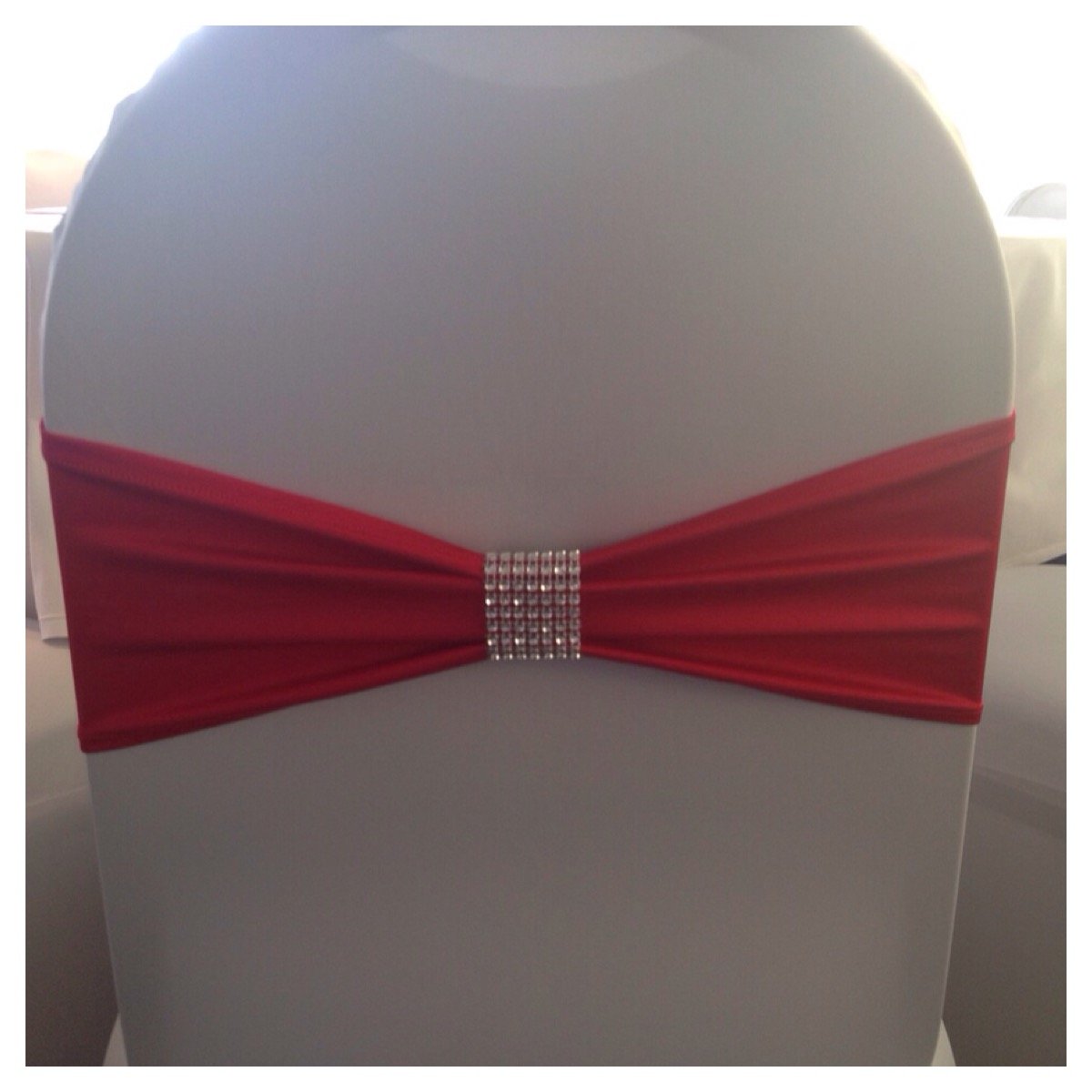 Red lycra band with bling wrap and white lycra chair covers at Friern Manor